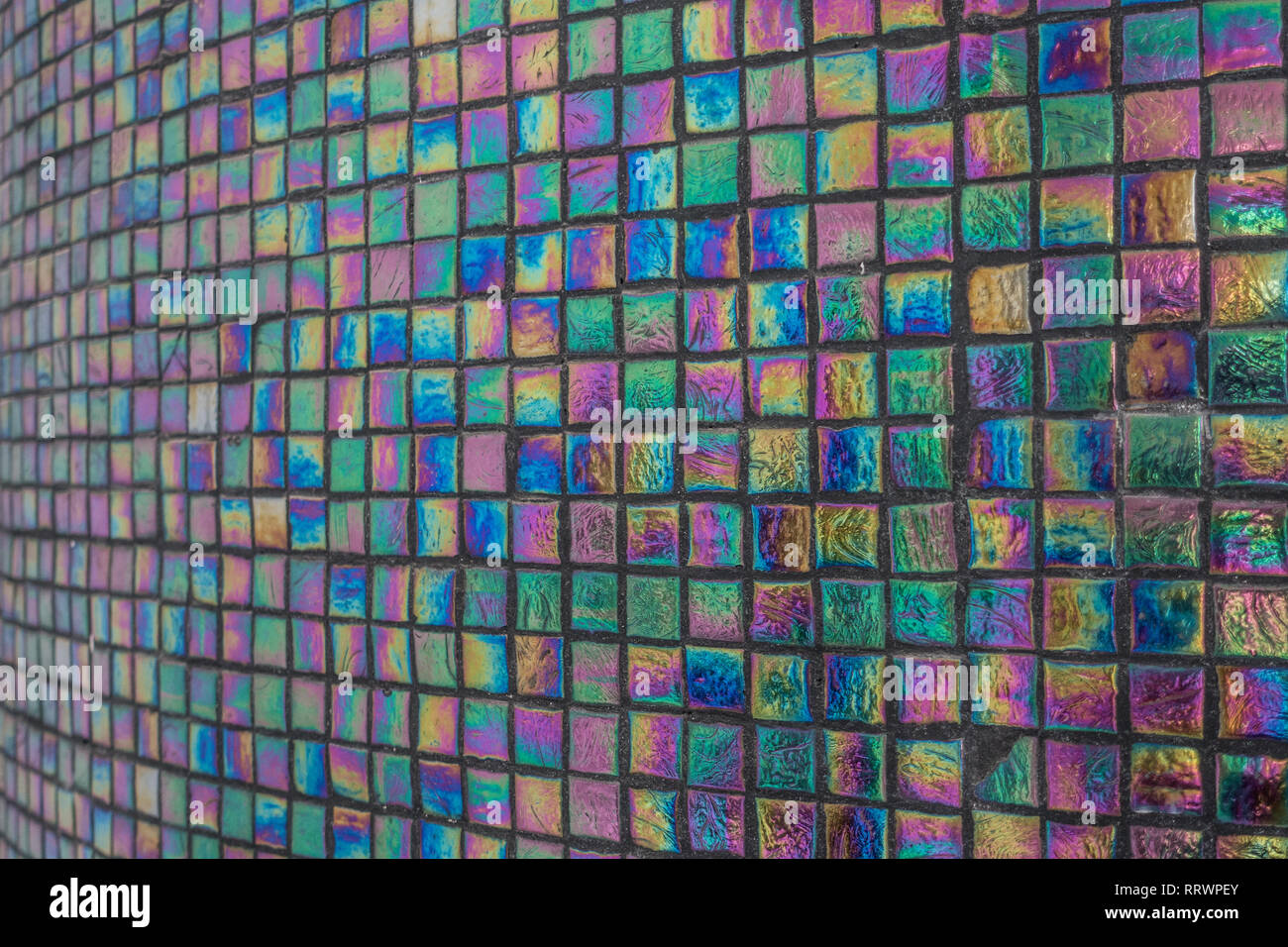 Iridescent tiled column with black grout Stock Photo