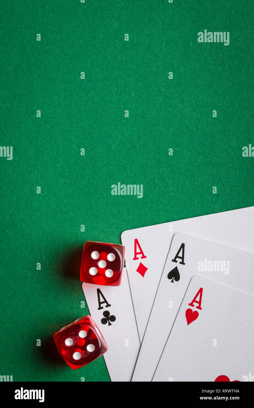 Poker cards and dice on green table. Stock Photo