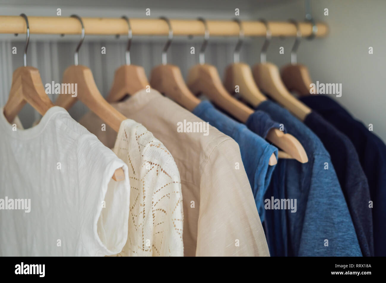 Old and new clothes in the closet on hangers and drawers. Second hand  reuse. Decluttering and cleaning the cabinet Stock Photo - Alamy