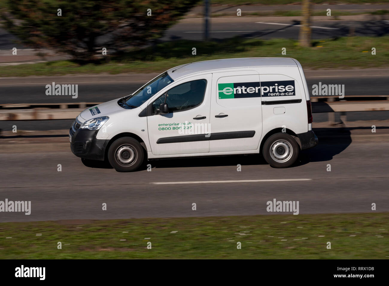 Enterprise rent a car rental white van driving on the road. Vehicle hire  company. Space for copy Stock Photo - Alamy