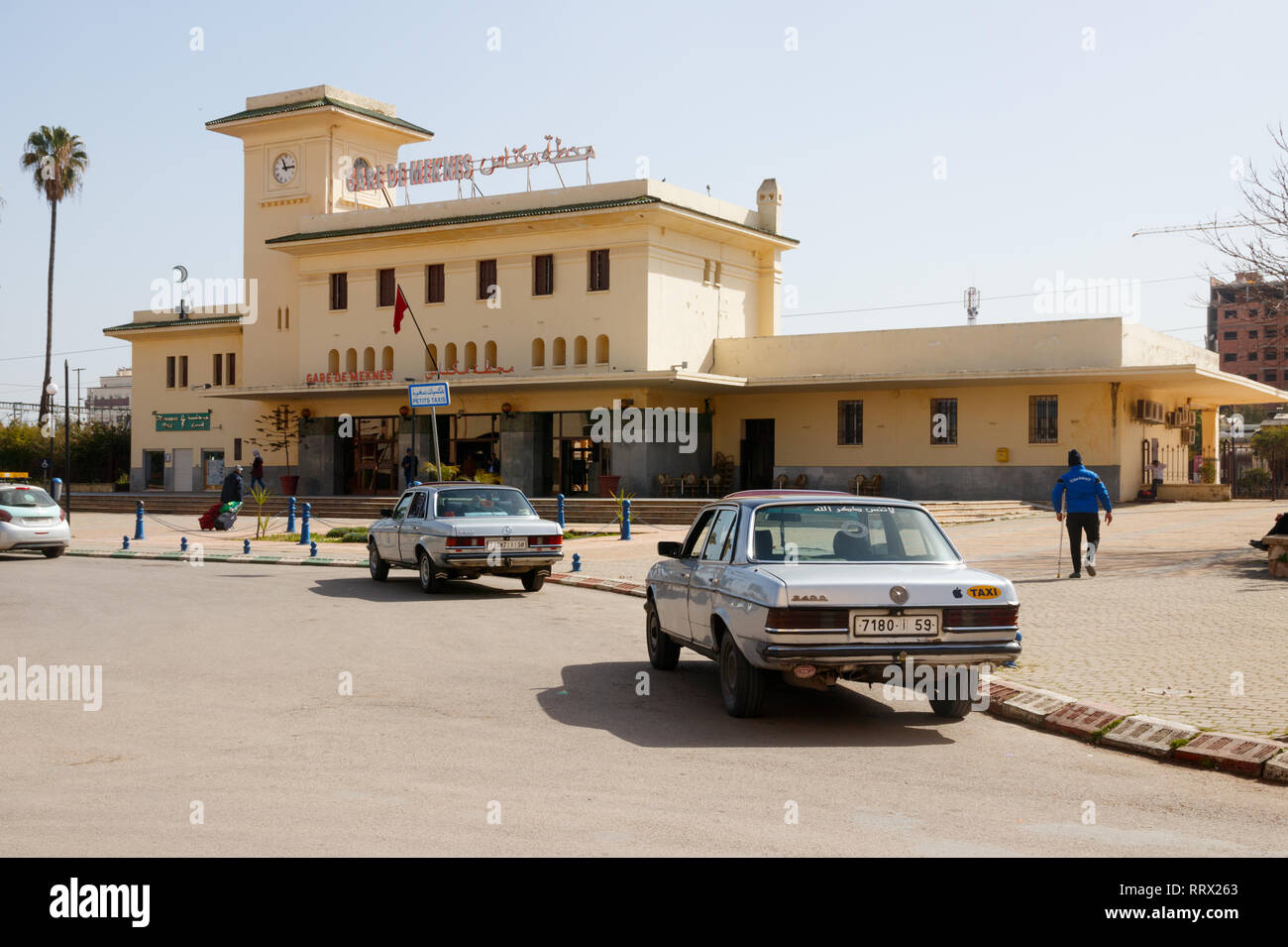 Avenue de la Gare with classic Mercedes taxis and the Meknes Station  building on a sunny day. Meknes, Morocco Stock Photo - Alamy