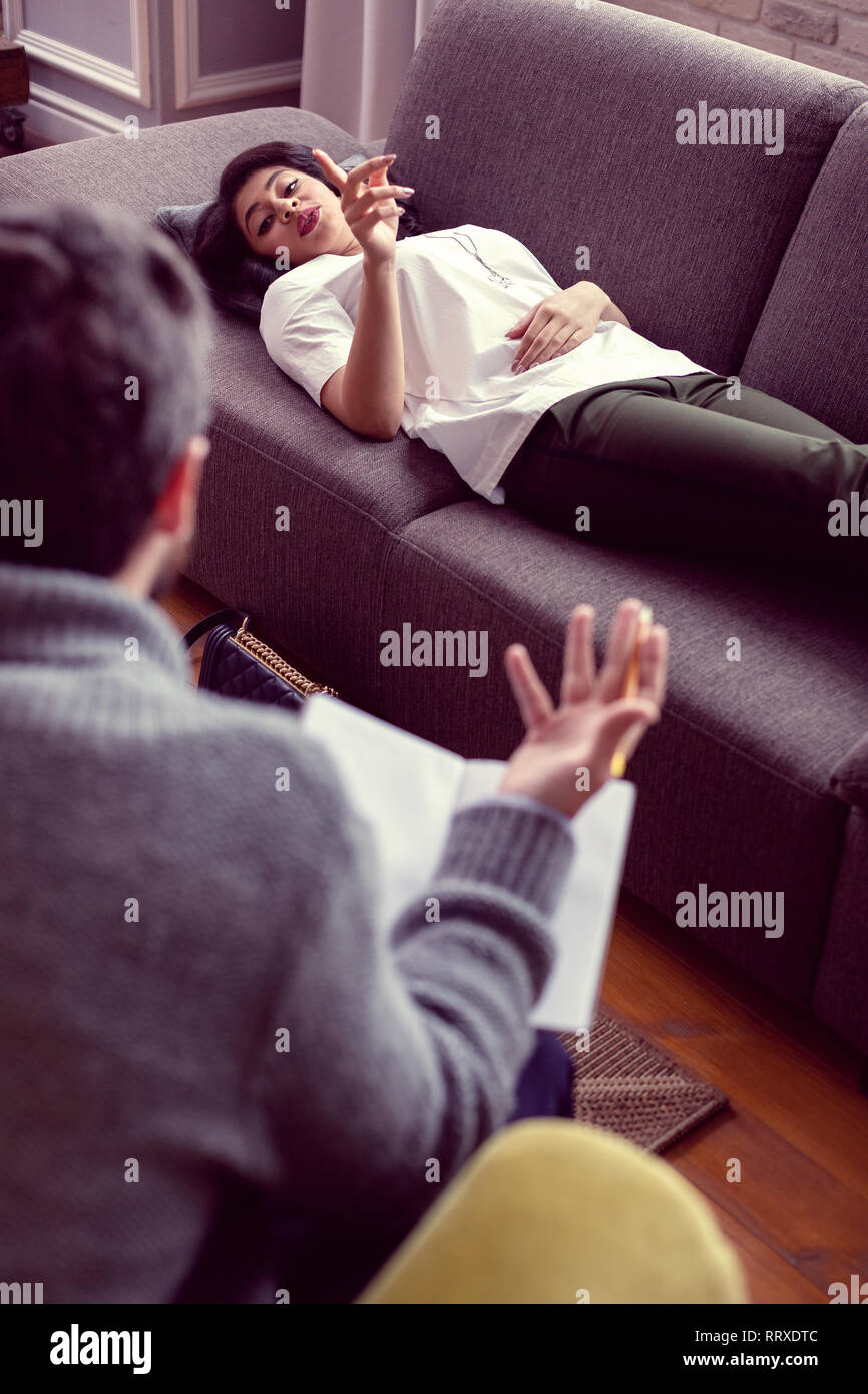 Nice beautiful young woman holding her finger up Stock Photo