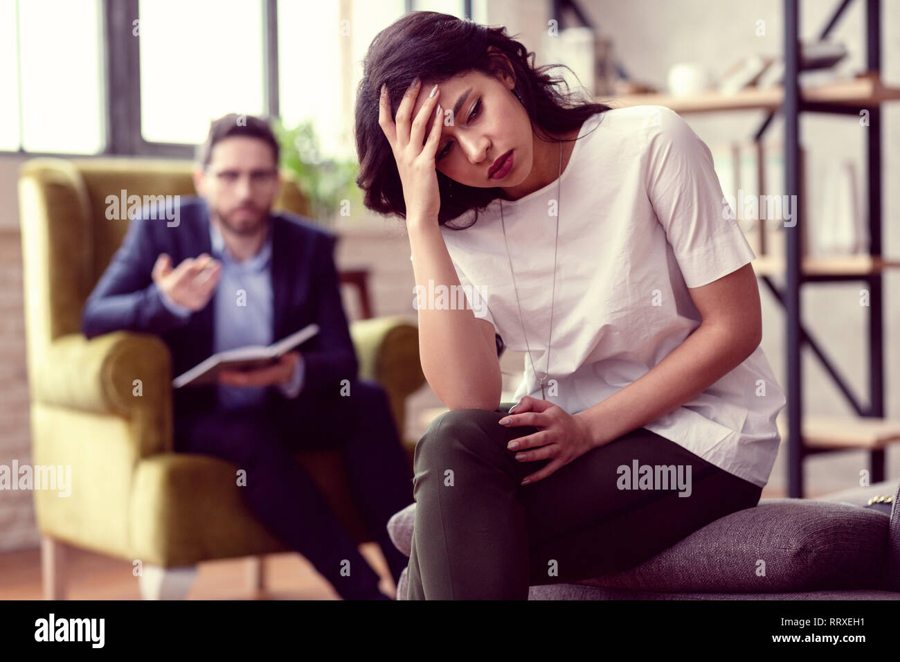 Beautiful young woman focusing on her problems Stock Photo
