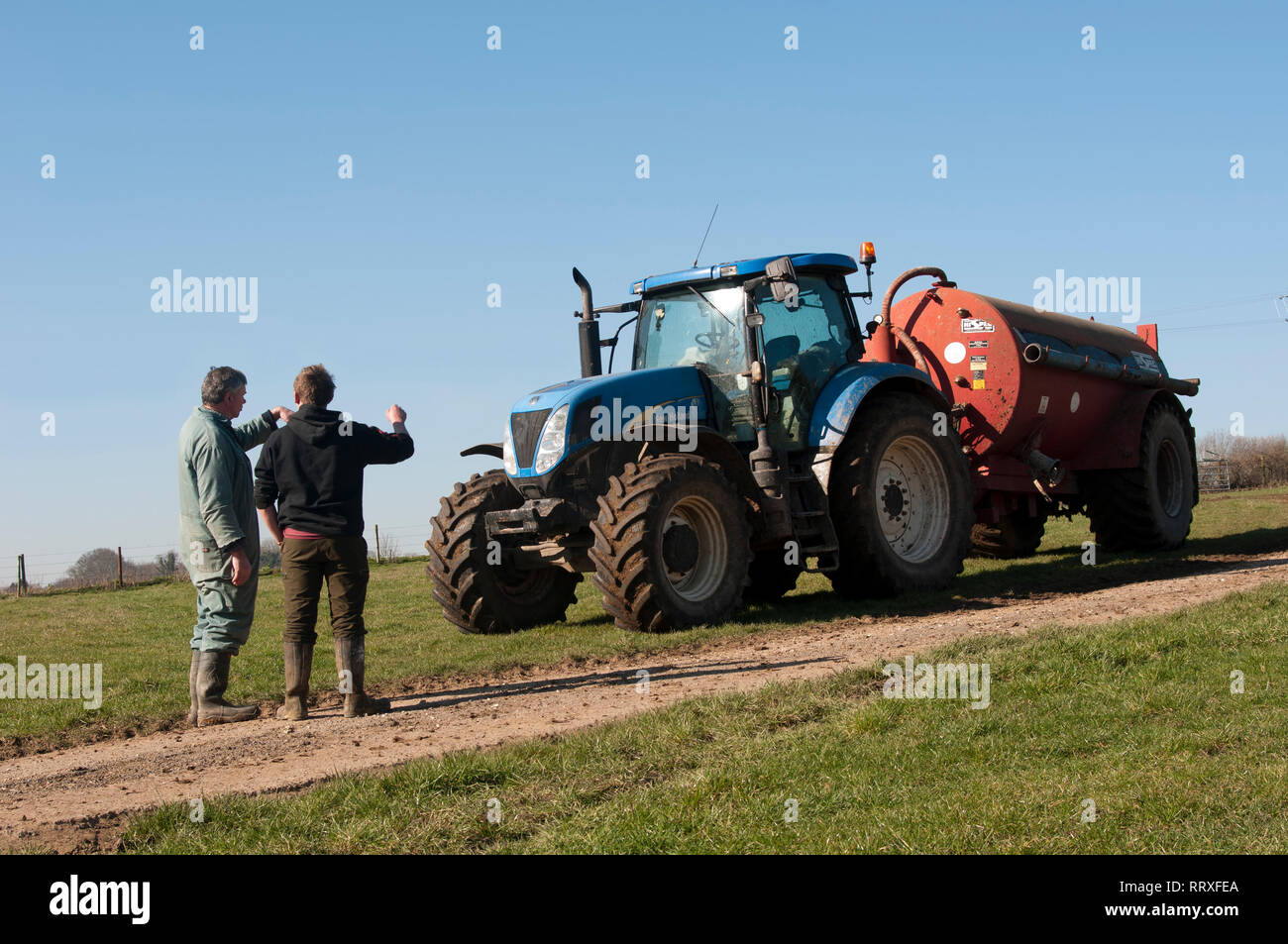 A farmer discusses muck spreading strategy with a contractor Stock Photo Alamy