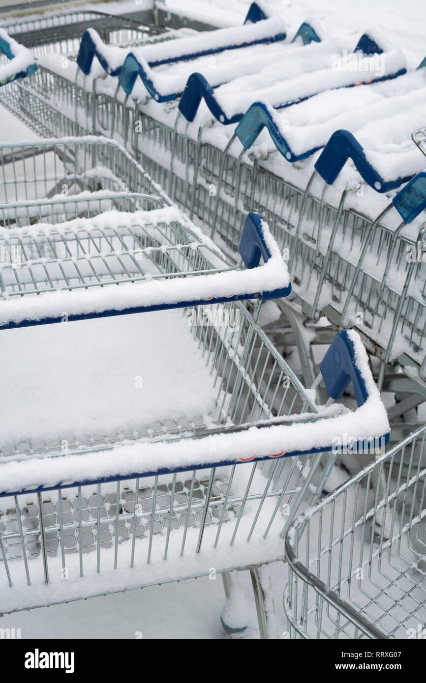 Tesco shopping trolleys in the winter snow Stock Photo