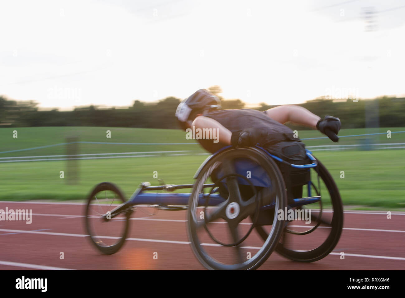 Paraplegic athlete speeding along sports track in wheelchair race Stock Photo