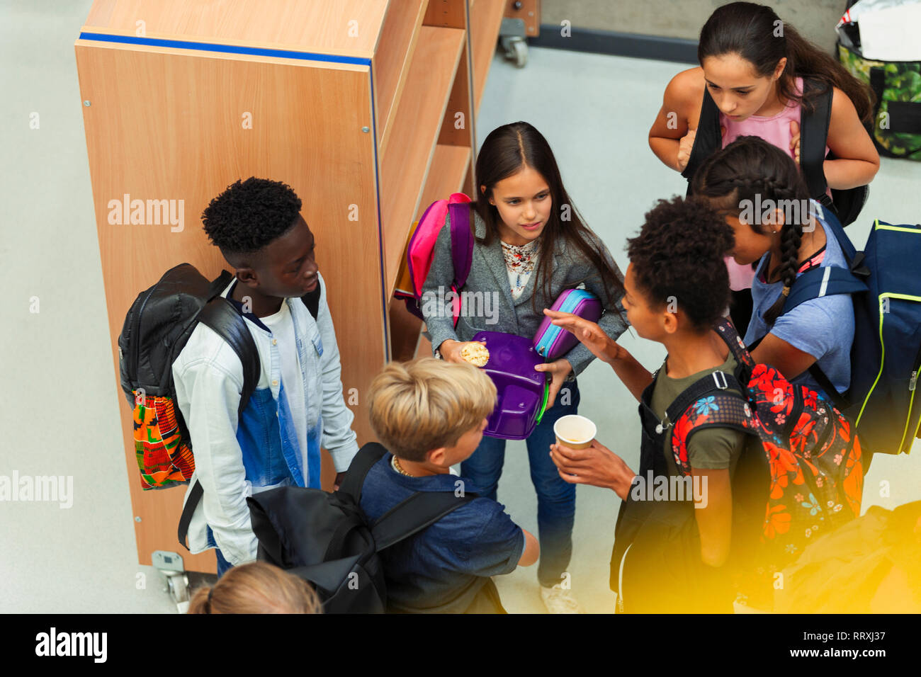 Junior high students talking in library Stock Photo