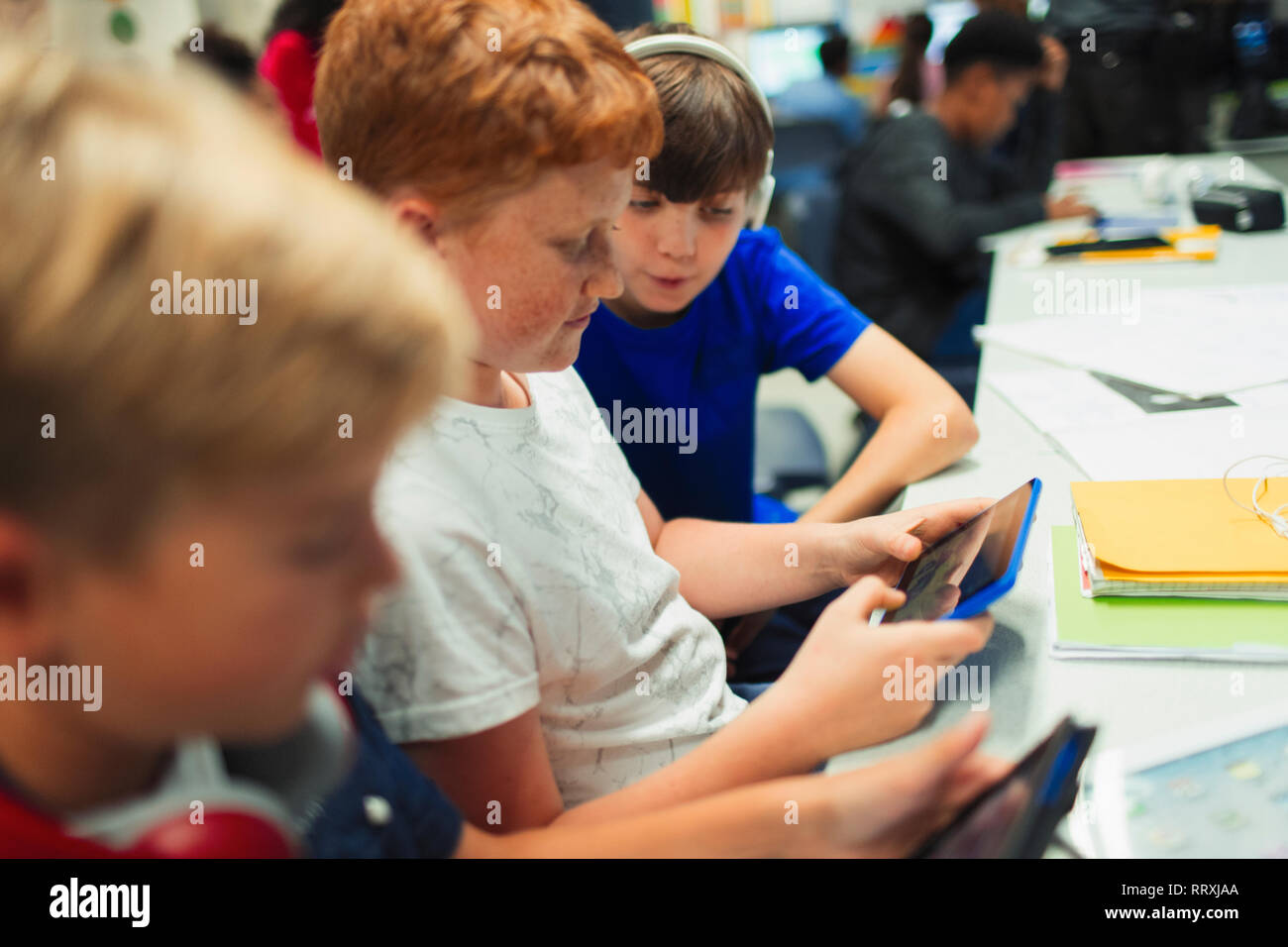 Junior high school boys using digital tablet in classroom Stock Photo