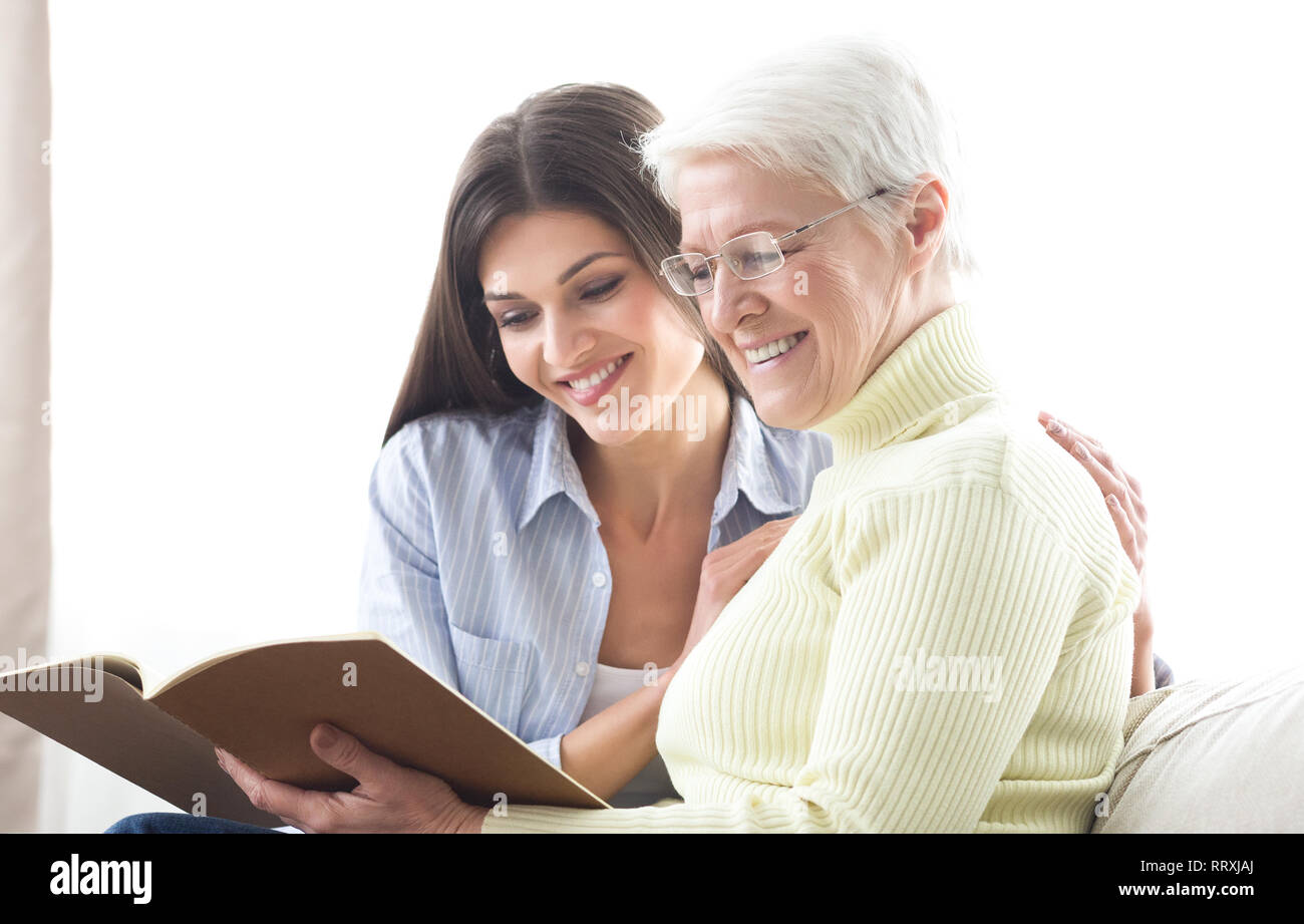 Senior mother and daughter looking catalog, searching new house Stock Photo