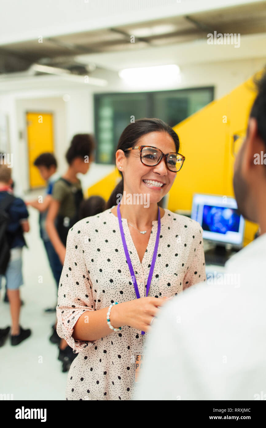 Happy female teacher talking with colleague Stock Photo