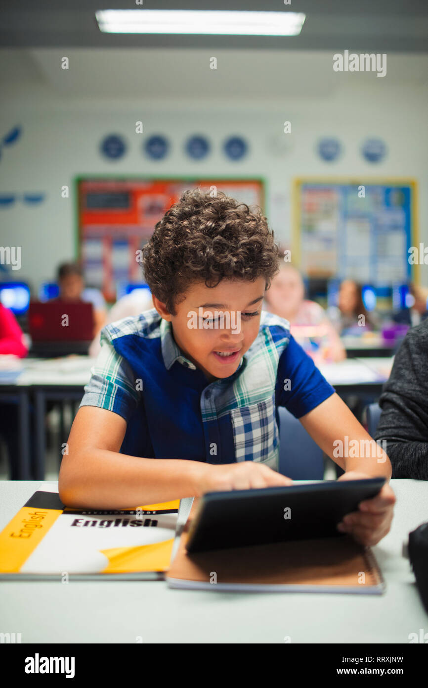 Junior high school boy student using digital tablet in classroom Stock Photo