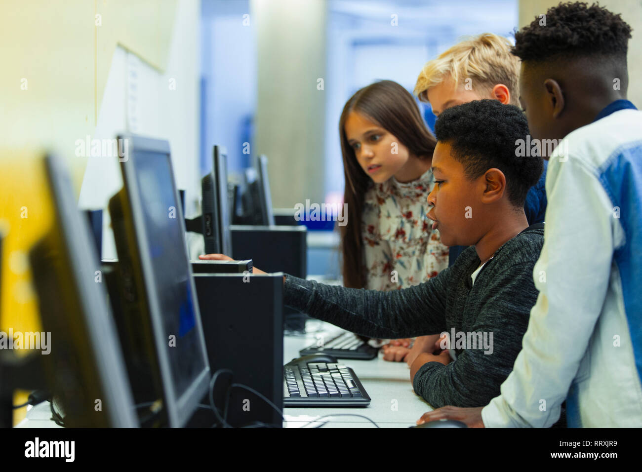 Junior high students using computer in computer lab Stock Photo