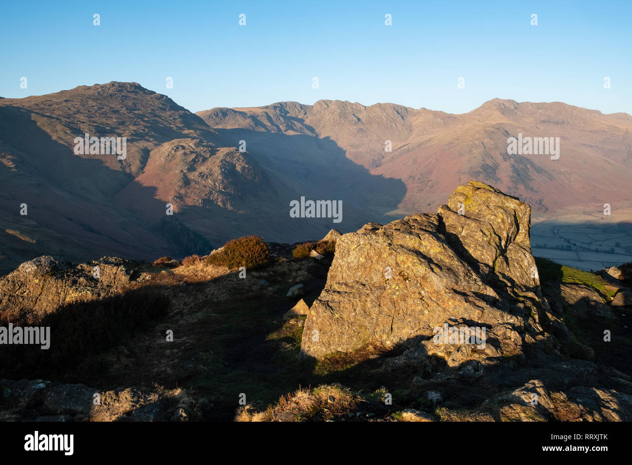 Early morning light over Pike of Blisco, Bowfell and Crinkle Crags at the head of Great Langdale, from Side Pike, Lake District, UK Stock Photo
