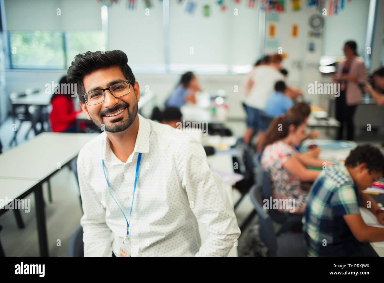 Portrait smiling, confident male teacher in classroom Stock Photo