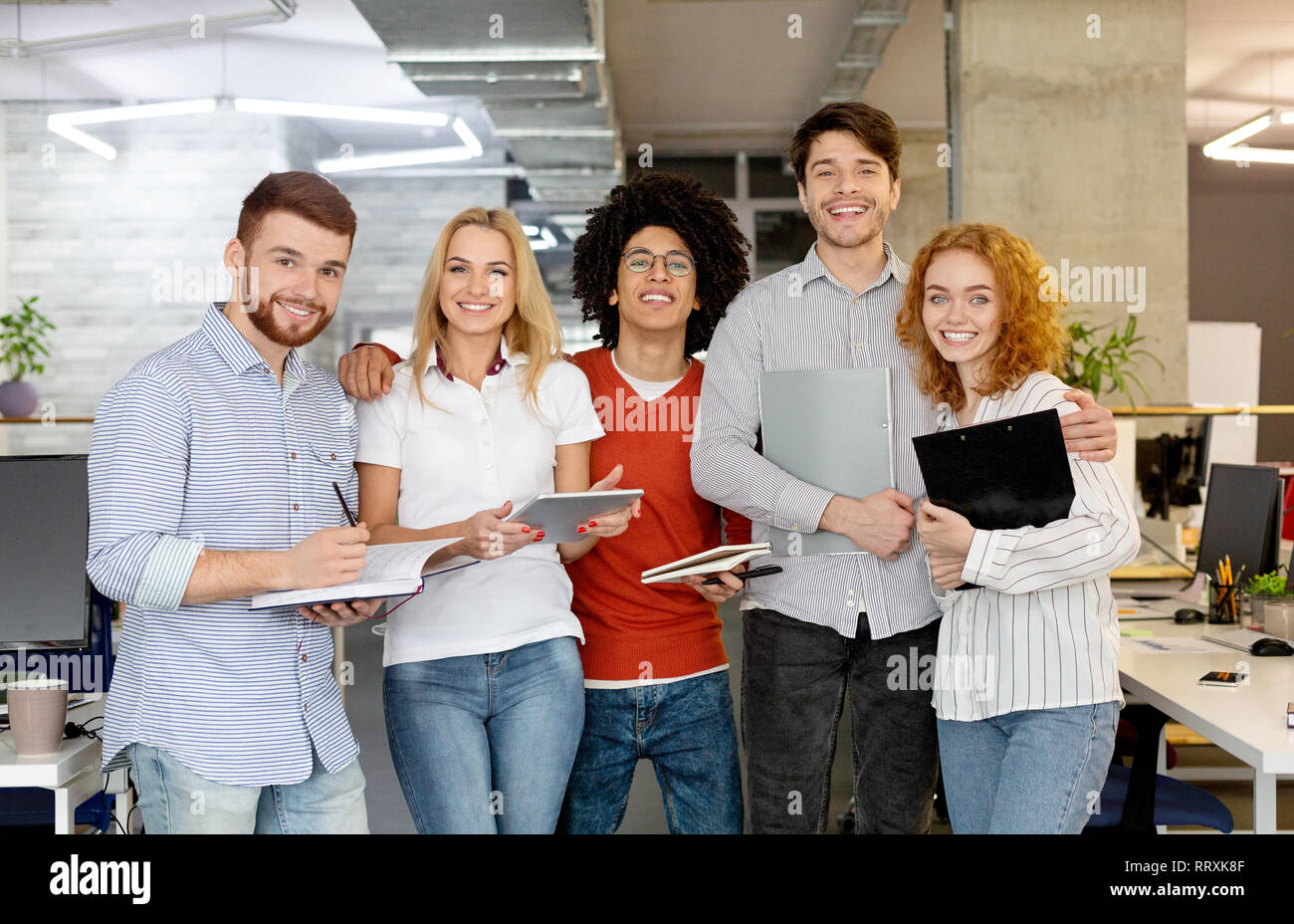 Diverse business people standing together and smiling Stock Photo - Alamy