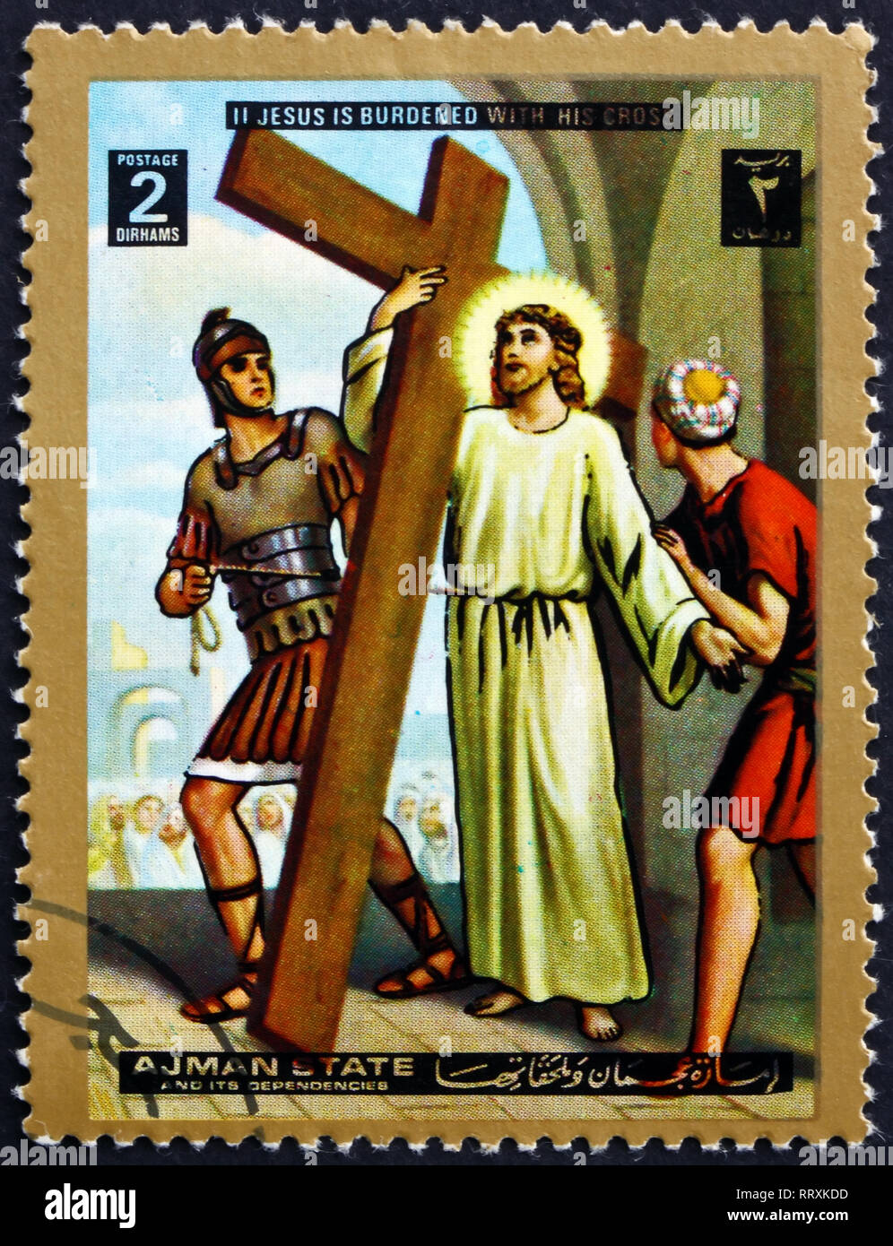 AJMAN - CIRCA 1973: a stamp printed in Ajman shows Jesus takes up his cross, stations of the cross, Easter, circa 1973 Stock Photo