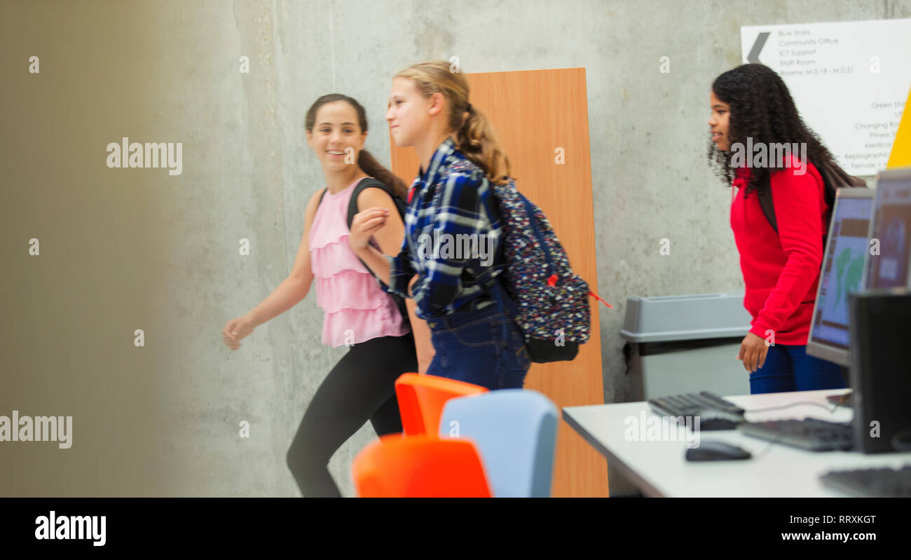 Junior high girl students walking in library Stock Photo