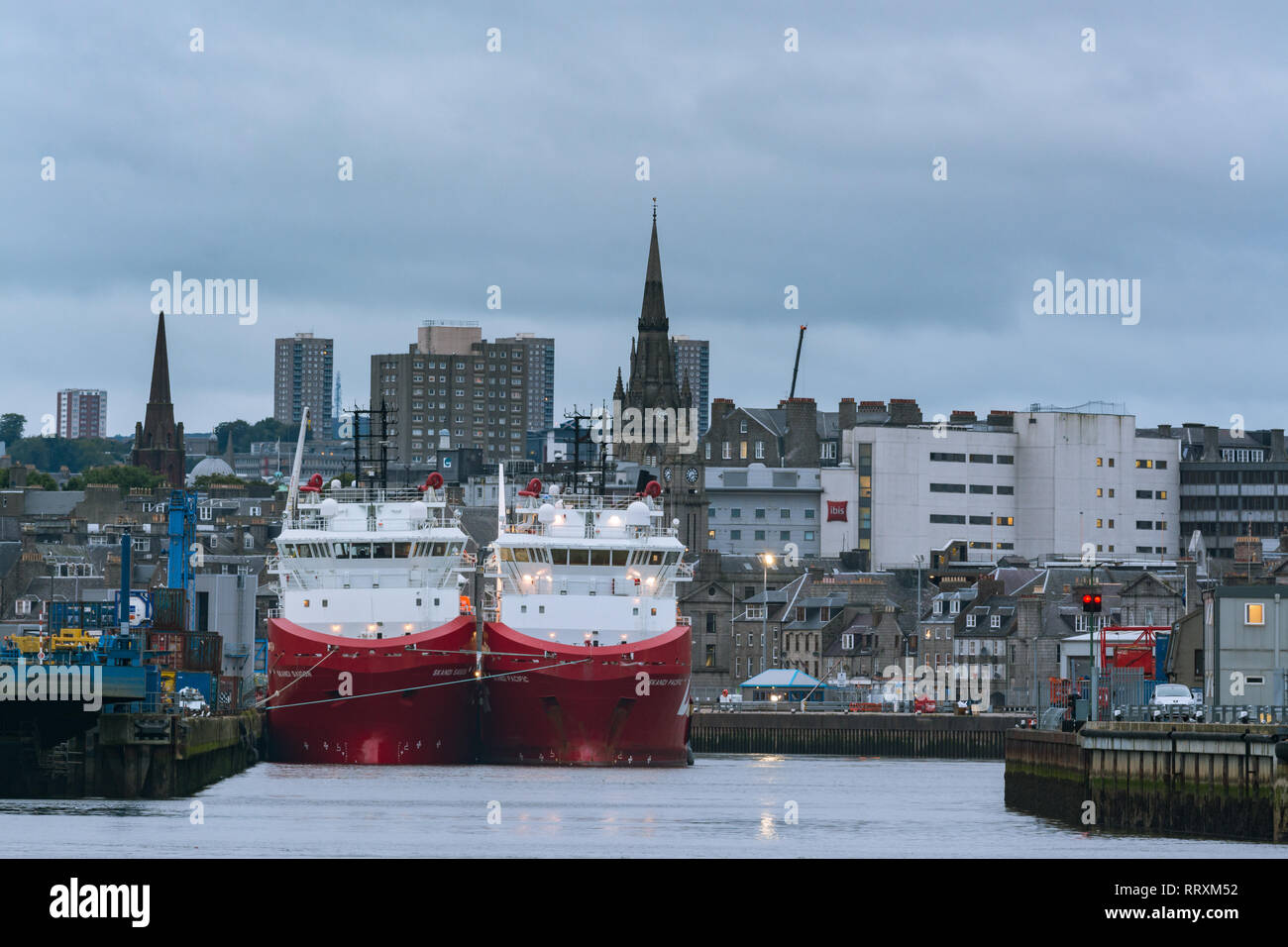 Offshore supply ships in Aberdeen harbour at dusk, Aberdeen, Scotland, UK Stock Photo