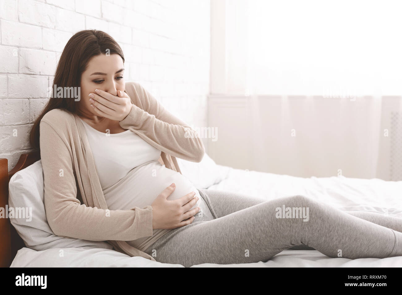 pregnant-woman-suffering-from-morning-nausea-in-bed-stock-photo-alamy