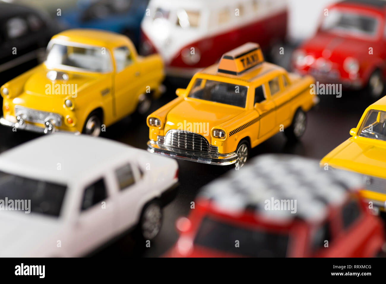 Izmir, Turkey - April  18, 2018: Various some brand toy cars on a black ground, looks like a traffic jam on the road. There is a taxi car on the cente Stock Photo