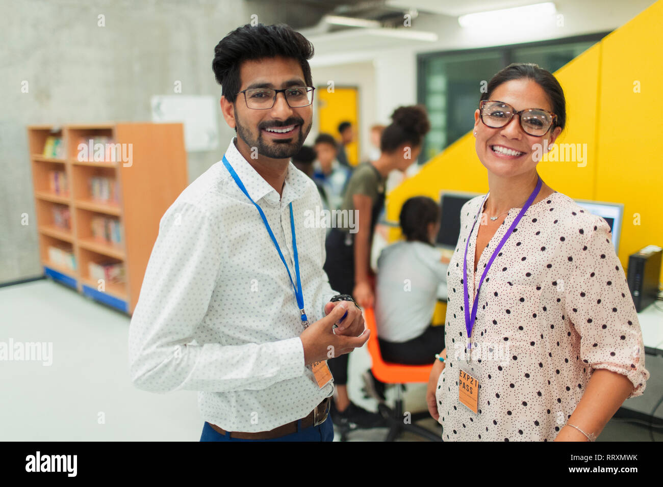 Portrait smiling, confident junior high teachers in library Stock Photo