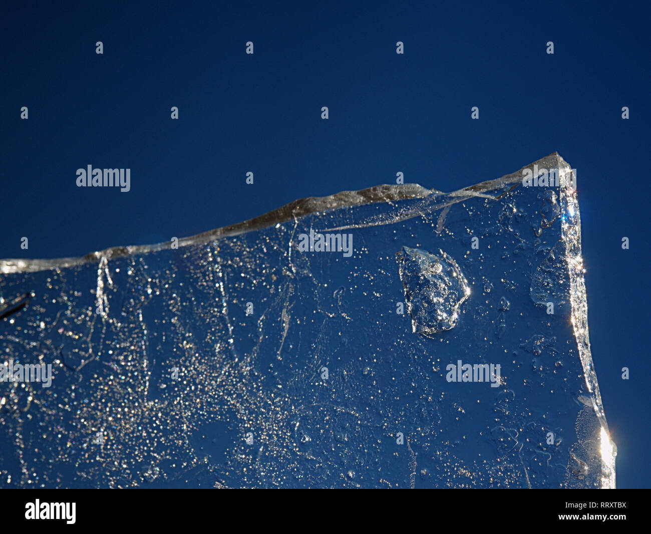 Ice against sky with hot sun. Melting of thin iceberg Stock Photo
