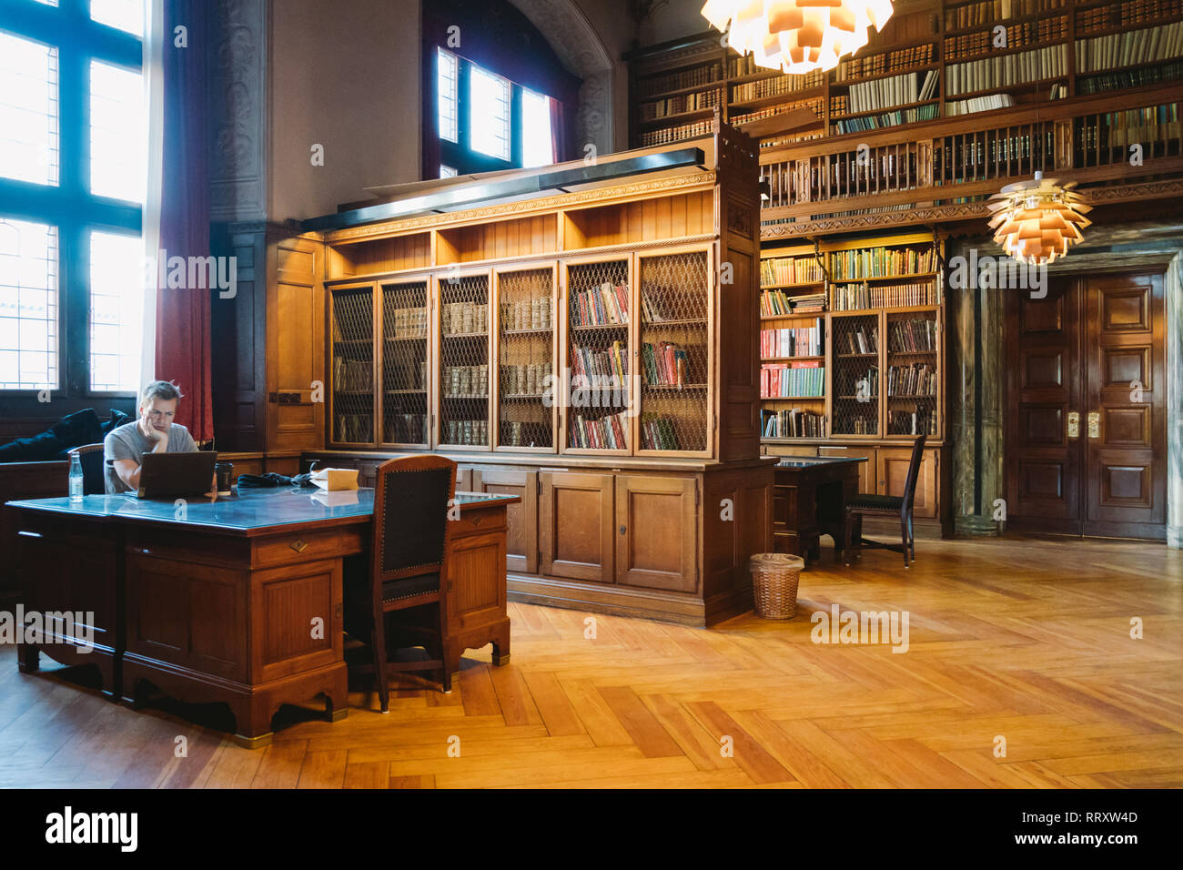 Storage of books. Large old library in the Gothic style. Shelves and ...