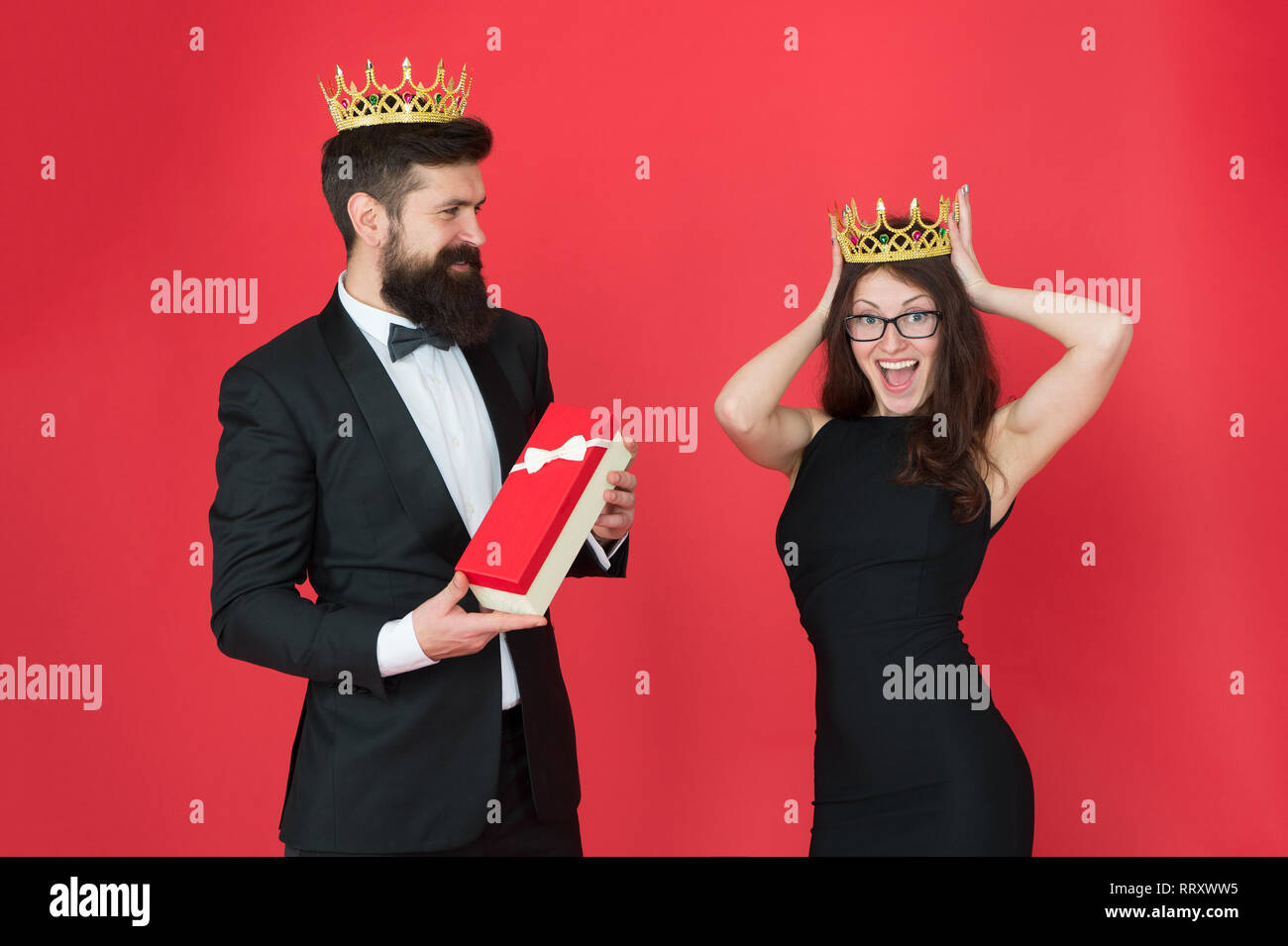 royal couple in love. date. business success. business fashion. anniversary party gift. Formal business couple. man in tuxedo and woman. Bearded man and happy woman in crown. Successful professional. Stock Photo