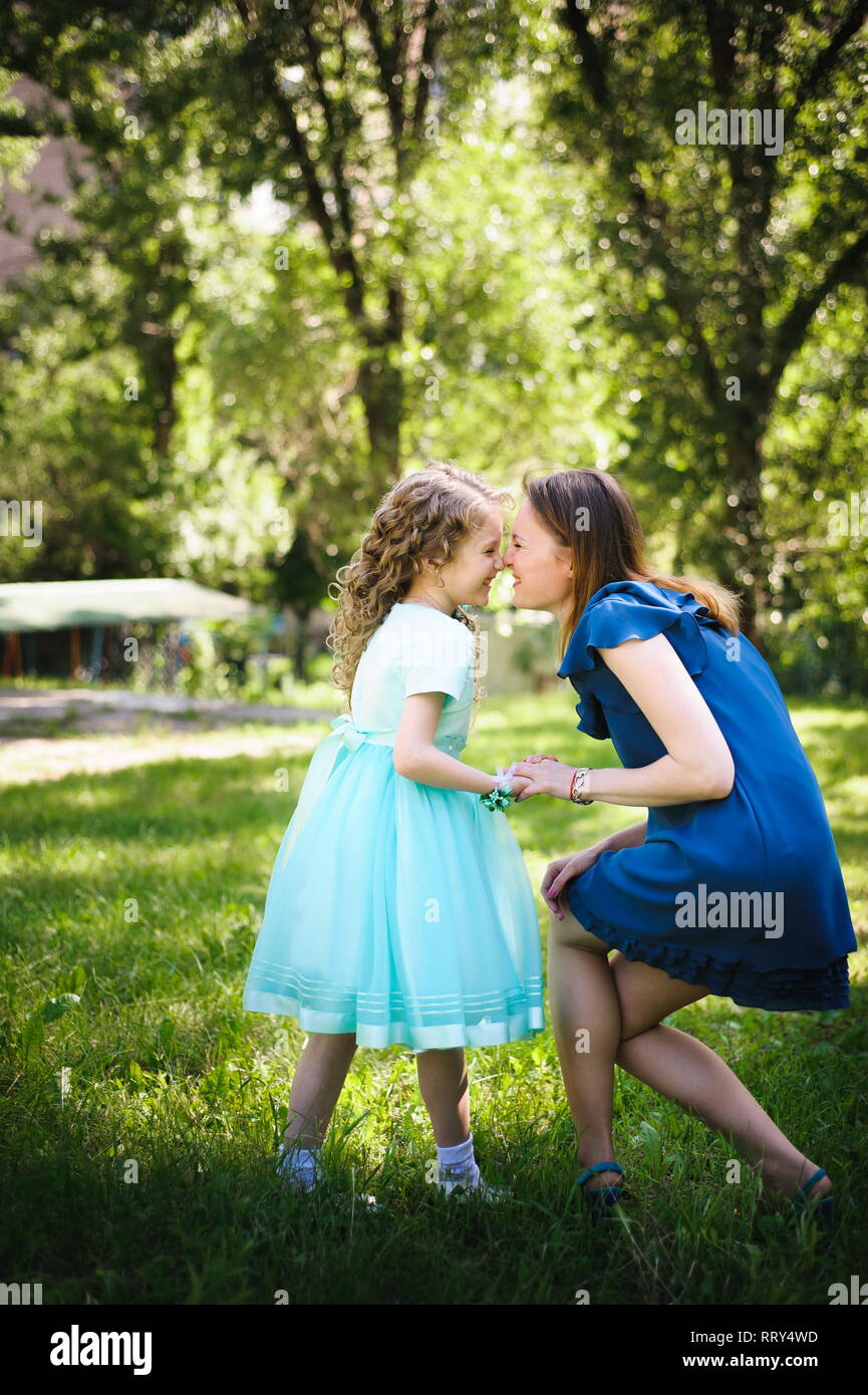 Happy mother and daughter together in a summer park outdoors Stock