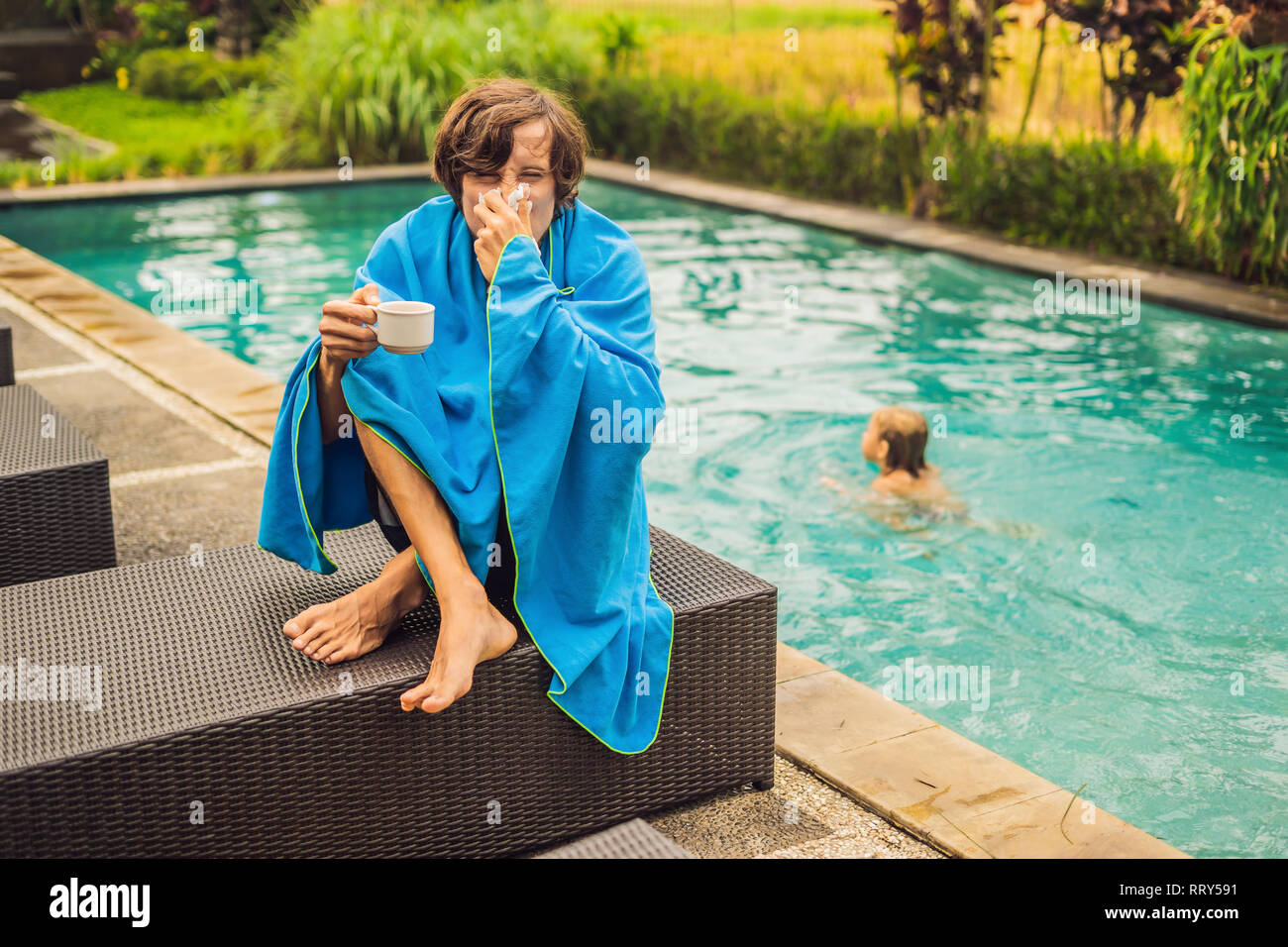 Sick man traveler. The man caught a cold on vacation, sits sad at the