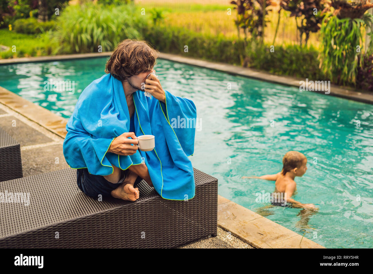 Sick man traveler. The man caught a cold on vacation, sits sad at the