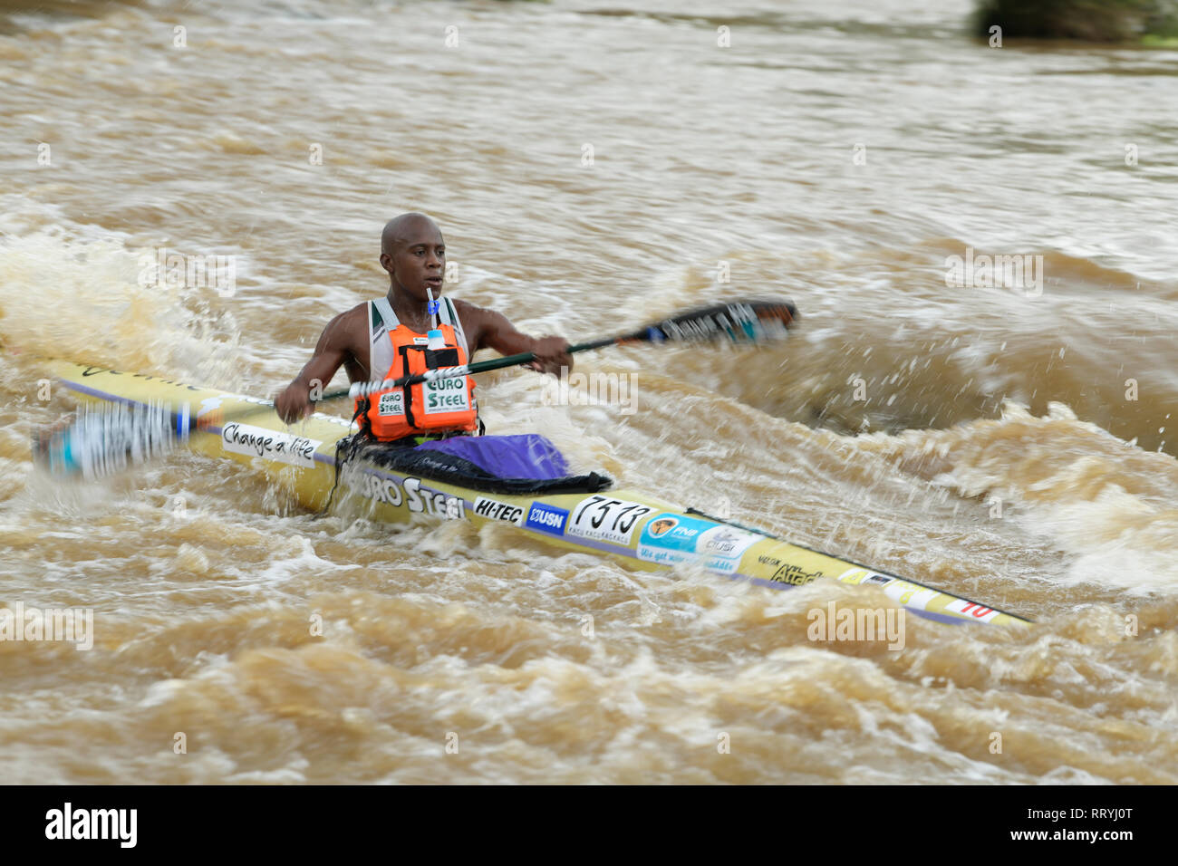 Durban, KwaZulu-Natal, South Africa, single adult man canoeing, competitor 2019 Dusi Canoe Marathon, paddle, blur, people, river Stock Photo