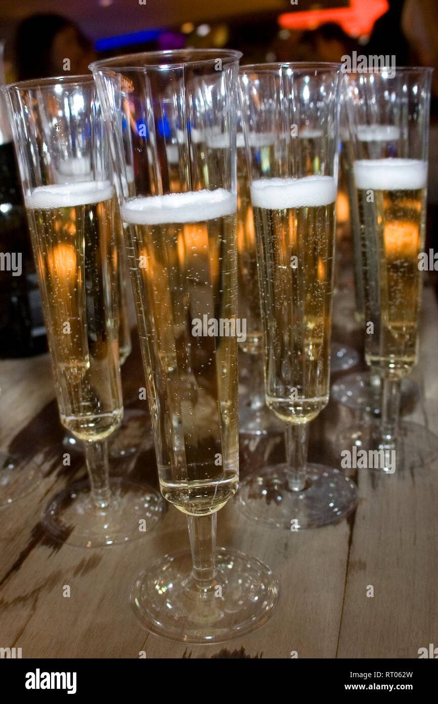 Glasses of champagne are poured and ready for a celebratory toast. Stock Photo