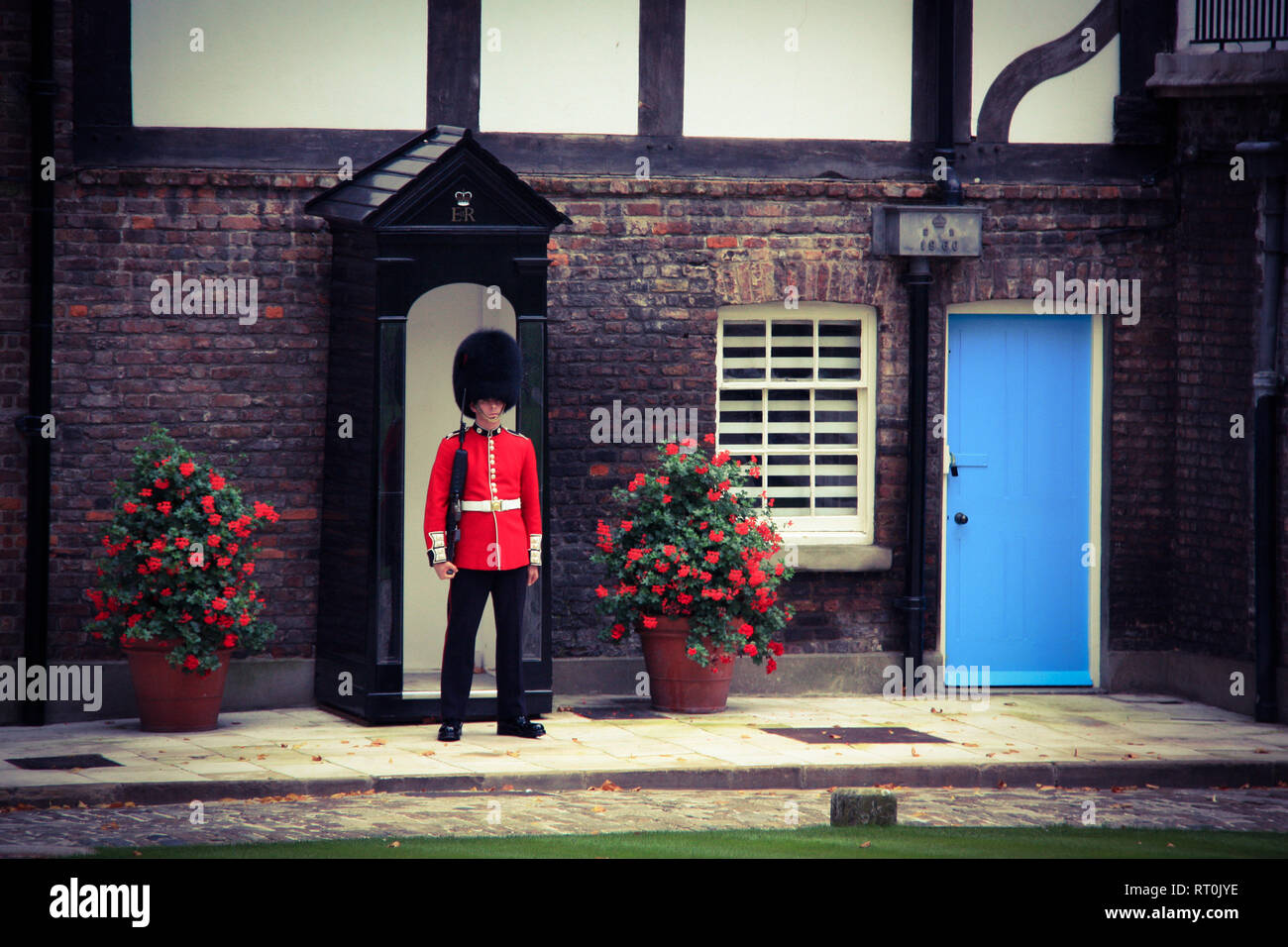 Grenadier Guard and sentry box in front of the Queen's House at Her Majesty's Royal Palace and Fortress of the Tower of London - London, UK Stock Photo