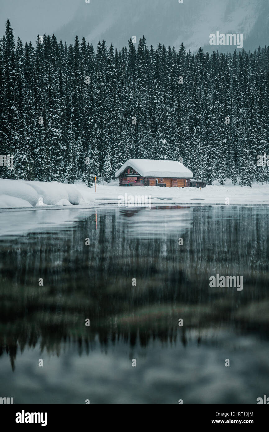 Winter mountain reflection in the calm clear water at Lake Louise in Banff National Park, Alberta, Canada Stock Photo