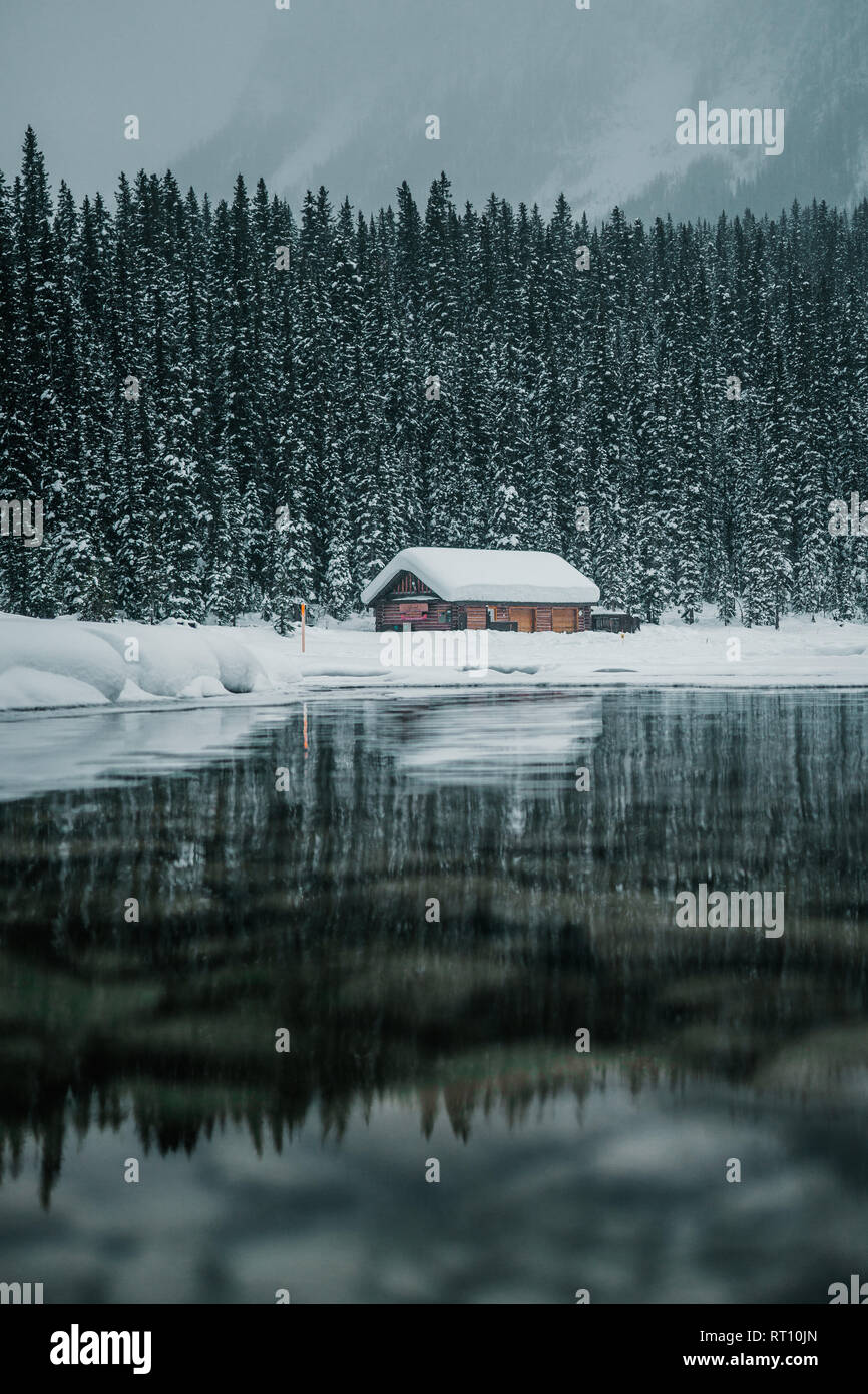 Winter mountain reflection in the calm clear water at Lake Louise in Banff National Park, Alberta, Canada Stock Photo