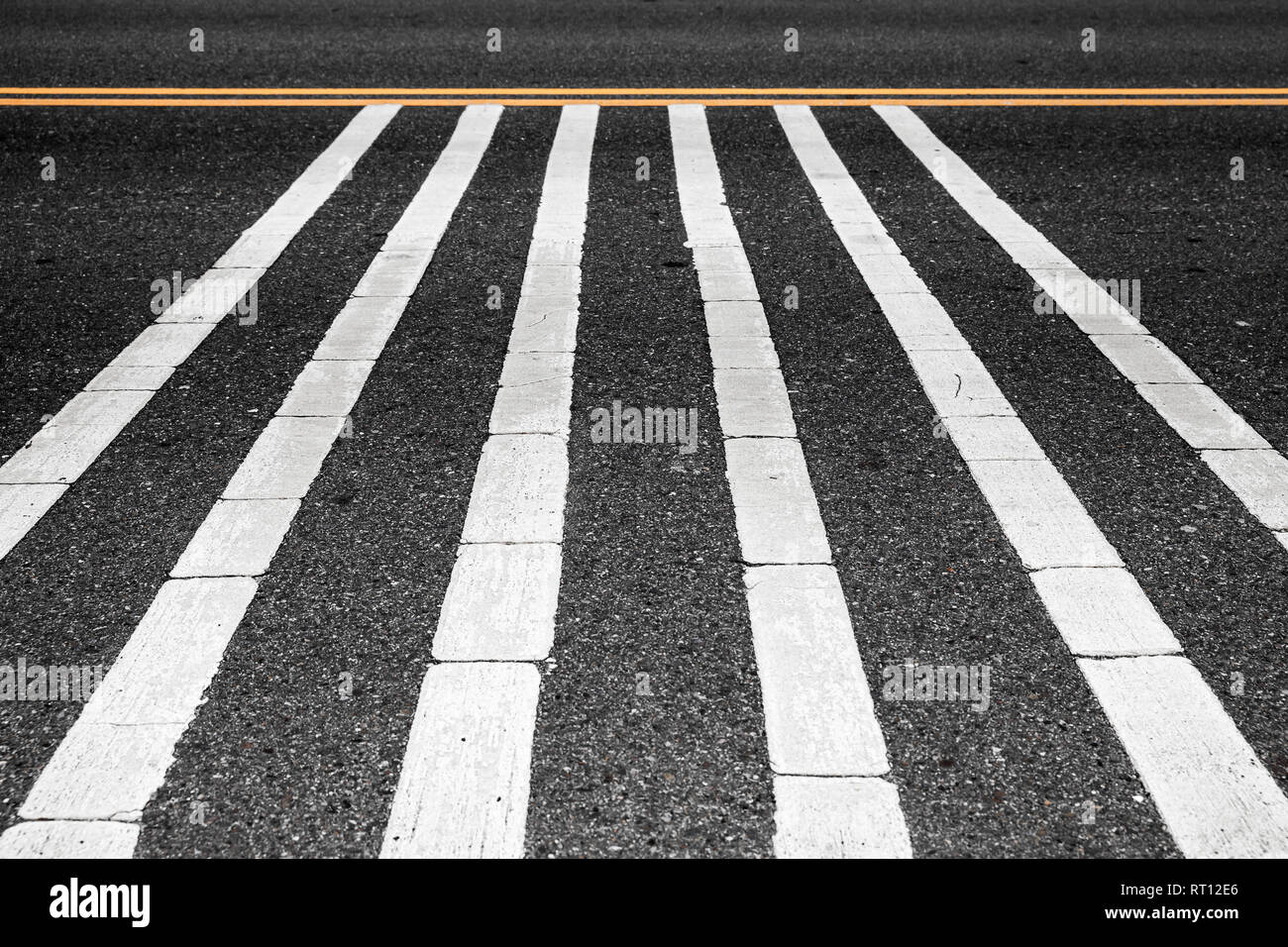 Rumble strips, also known as sleeper lines, alert strips, audible lines, sleepy bumps, wake up calls, growlers, drift lines, and drunk bumps, are a ro Stock Photo