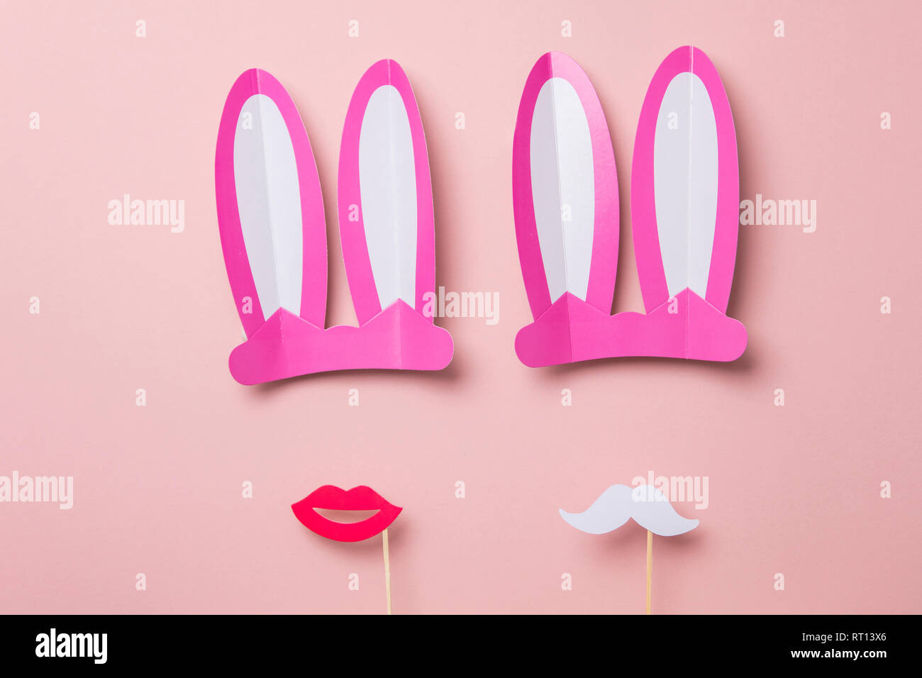 Pink Easter bunny ears and red lips. Minimal lay flat design Stock Photo