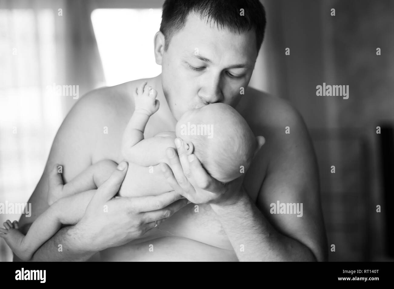 happy father kissing his newborn daughter. photo in retro style Stock Photo