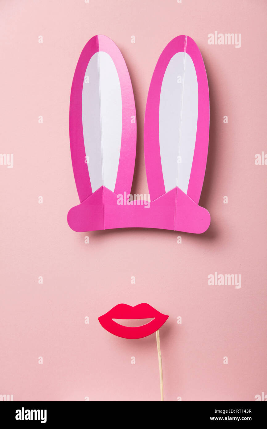 Pink Easter bunny ears and red lips. Minimal lay flat design Stock Photo