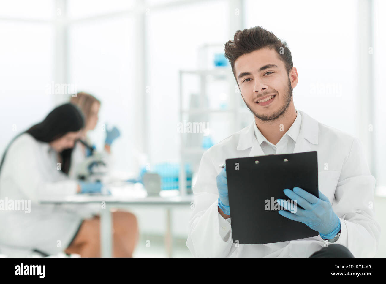 close up. a scientist doing writes the results of an experiment to a laboratory journal Stock Photo