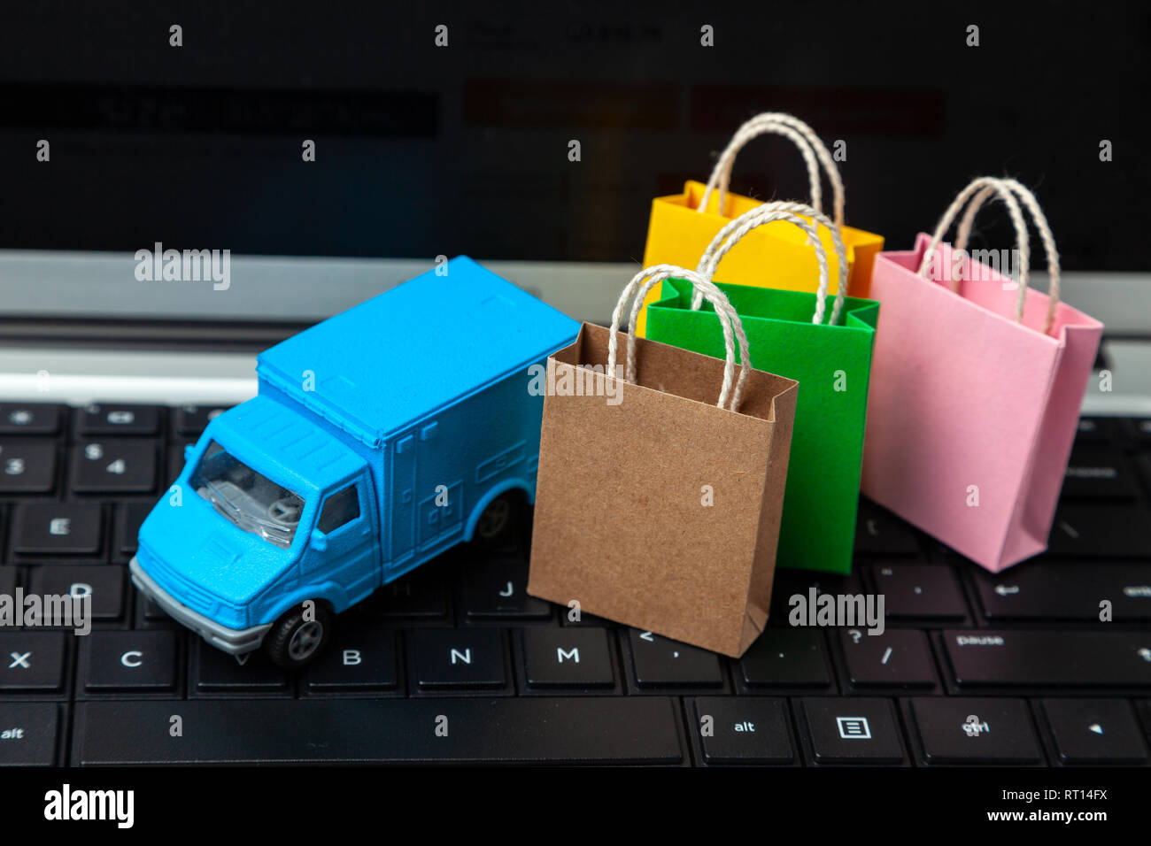 Delivery of orders from the online store. Shopping bags on the laptop