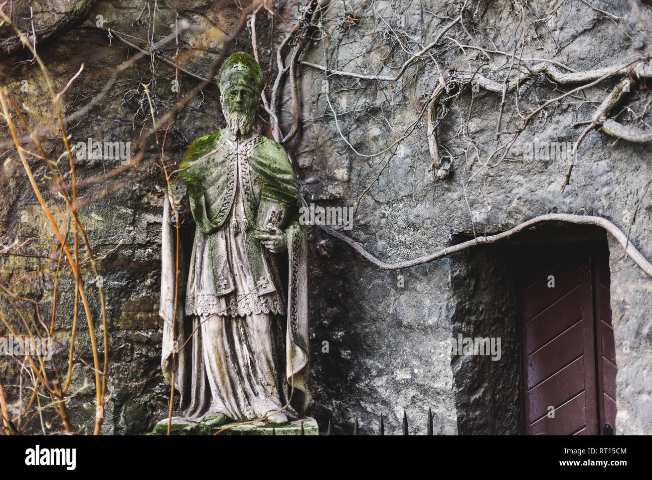 Vienna, Austria - December 30, 2017. Statue of Saint Rupert outside St. Ruprecht's Church - oldest in the Vienna. Medieval saint sculpture built in 8t Stock Photo