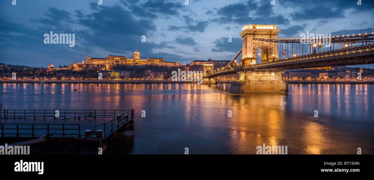 The Széchenyi Chain Bridge and the Danube river with the castle hill in the background  illuminated at night. Budapest, Hungary. Stock Photo