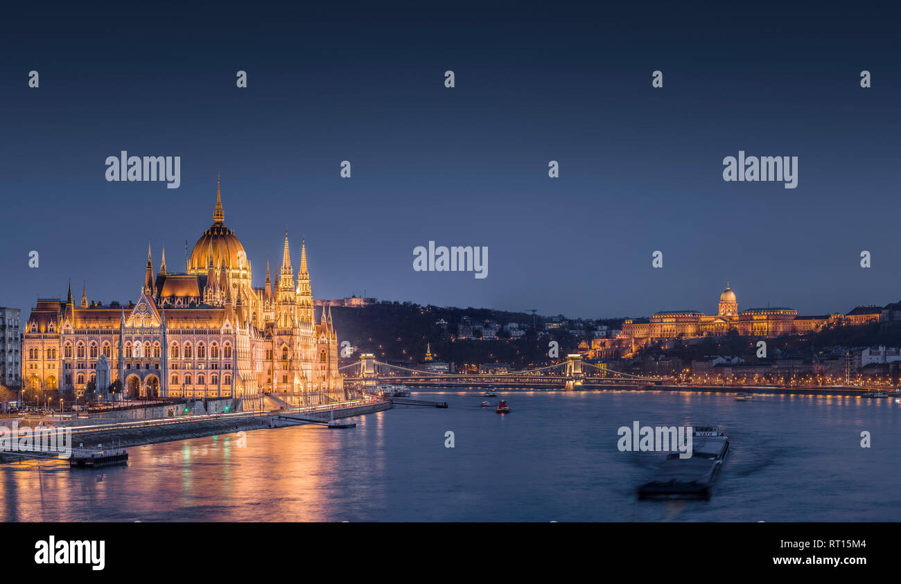 Hungarian parliament building and the banks of the Danube river, with the castle hill illuminated at night. Budapest, Hungary. Stock Photo