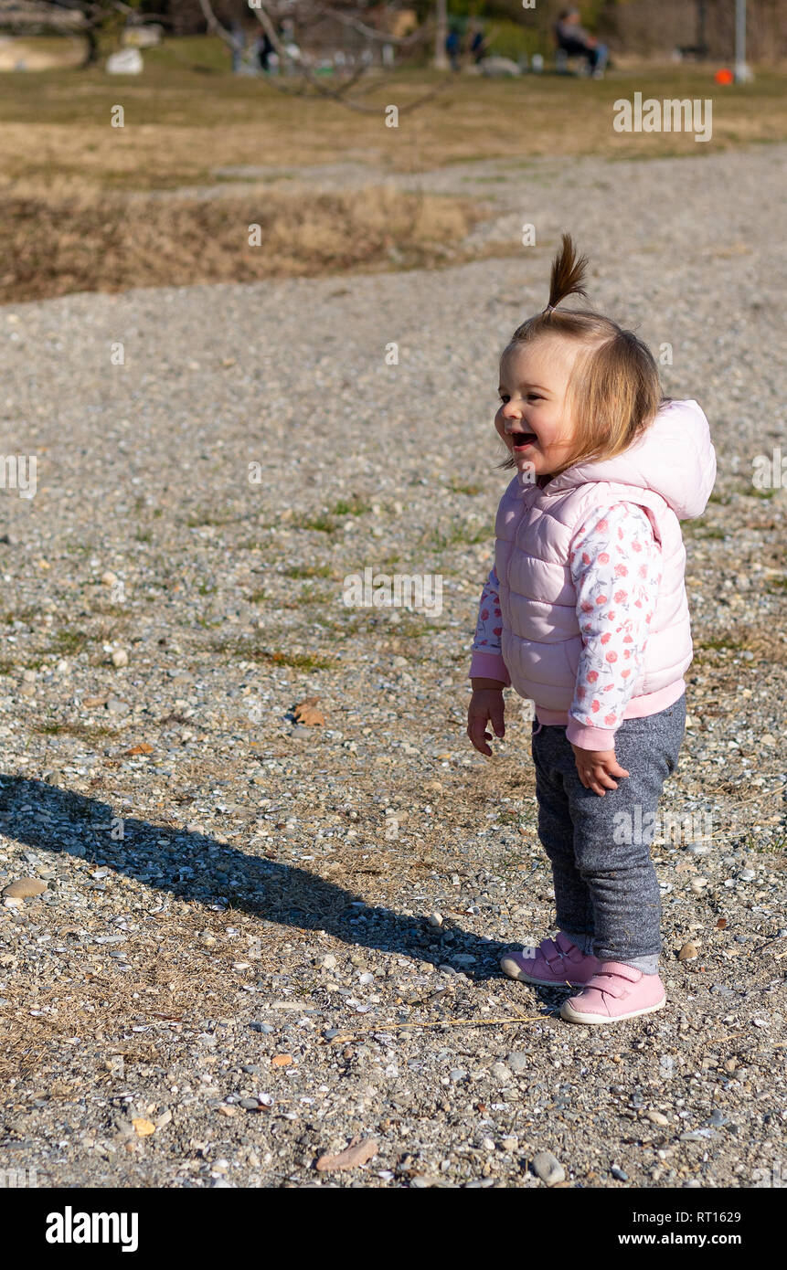 Beautiful 16 months old baby girl standing and laughing on the beach. Lake  Leman near the Lausanne city. Switzerland Stock Photo - Alamy