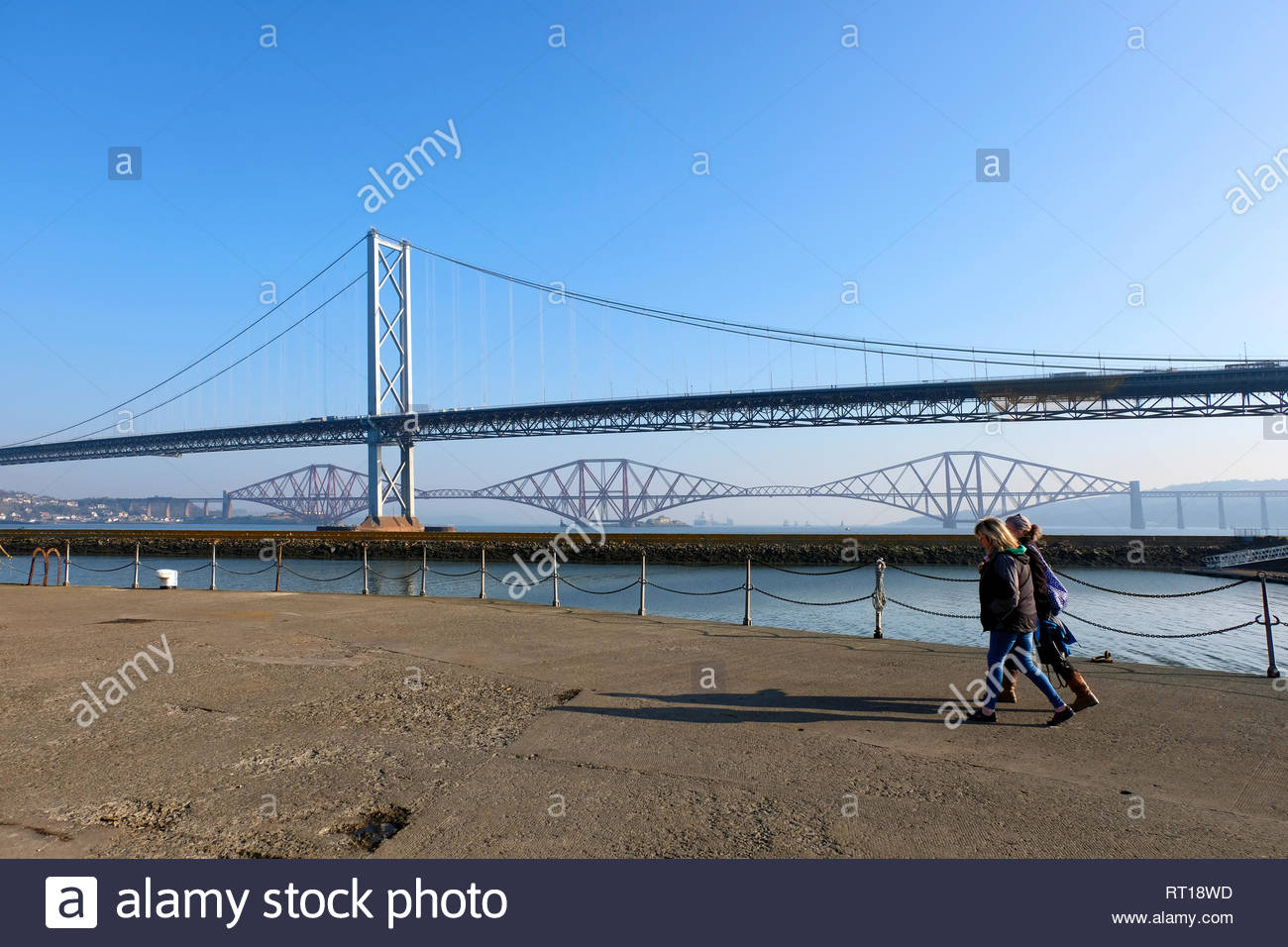 South Queensferry, United Kingdom. 27th February 2019. Unusually mild weather with sunshine at Port Edgar Marina with views of the Forth bridges. Credit: Craig Brown/Alamy Live News Stock Photo