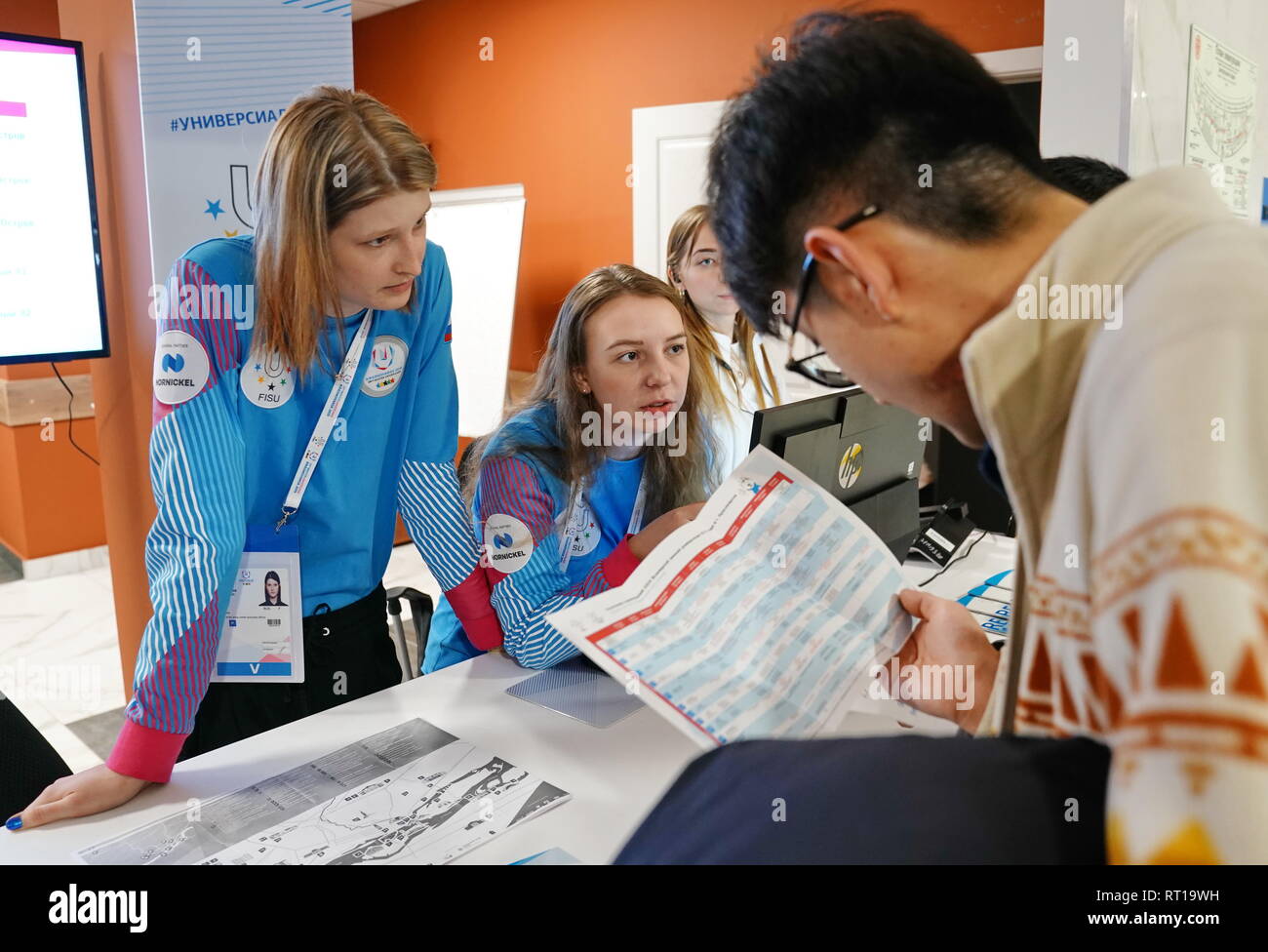 Krasnoyarsk. 27th Feb, 2019. Volunteers offer consultation for journalists in the main press center of the 29th Winter Universiade in Krasnoyarsk, Russia on Feb. 27, 2019. Credit: Yang Shiyao/Xinhua/Alamy Live News Stock Photo