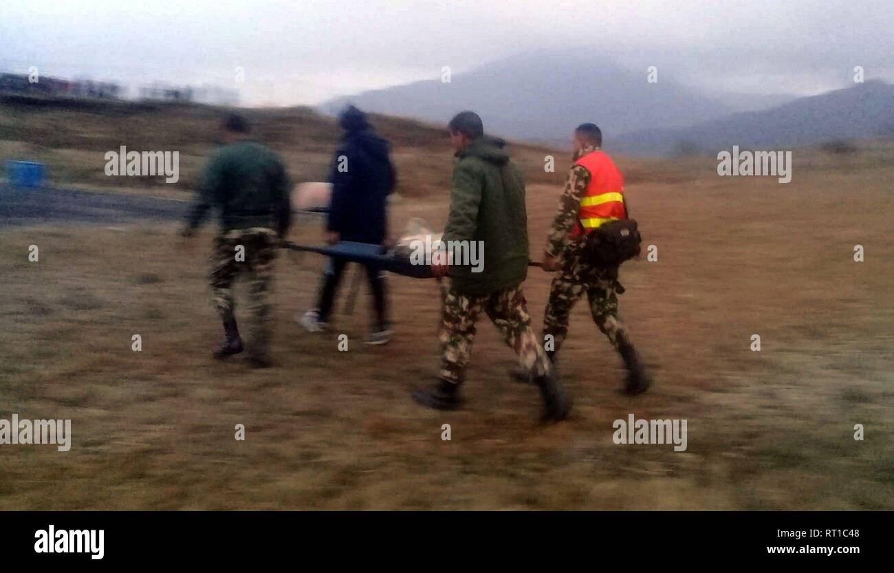 (190227) -- TAPLEJUNG, Feb. 27, 2019 (Xinhua) -- Security personnel carry the remains of dead bodies from aircraft crash site to bring towards Kathmandu at Suketar Airport in Taplejung, Nepal, Feb. 27, 2019. All seven people onboard were confirmed dead, including Nepal's Tourism Minister Rabindra Adhikari, in a helicopter crash in Taplejung district of eastern Nepal Wednesday afternoon, Spokesperson of Nepal Police Uttam Raj Subedi confirmed. (Xinhua) Stock Photo