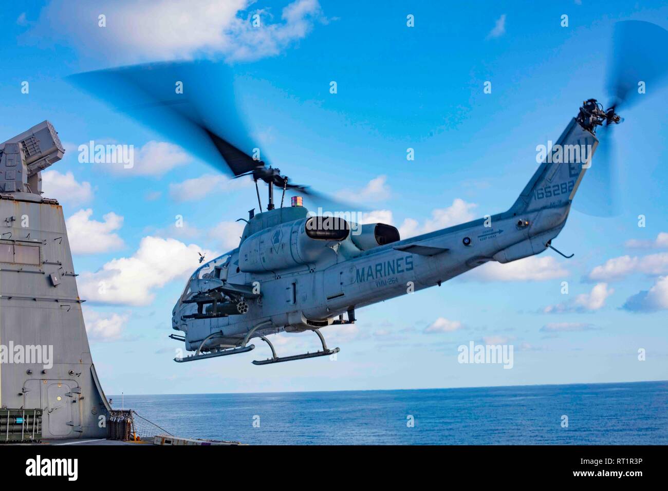 190221-N-HG389-0015 MEDITERRANEAN SEA (Feb. 21, 2019) An AH-1W Super Cobra helicopter assigned to the “Black Knights” of Marine Medium Tiltrotor Squadron (VMM) 264 (Reinforced) departs the flight deck of the San Antonio-class amphibious transport dock ship USS Arlington (LPD 24), Feb. 21, 2019. Arlington is on a scheduled deployment as part of the Kearsarge Amphibious Ready Group in support of maritime security operations, crisis response and theater security cooperation, while also providing a forward naval presence. (U.S. Navy photo by Mass Communication Specialist 2nd Class Brandon Parker/R Stock Photo